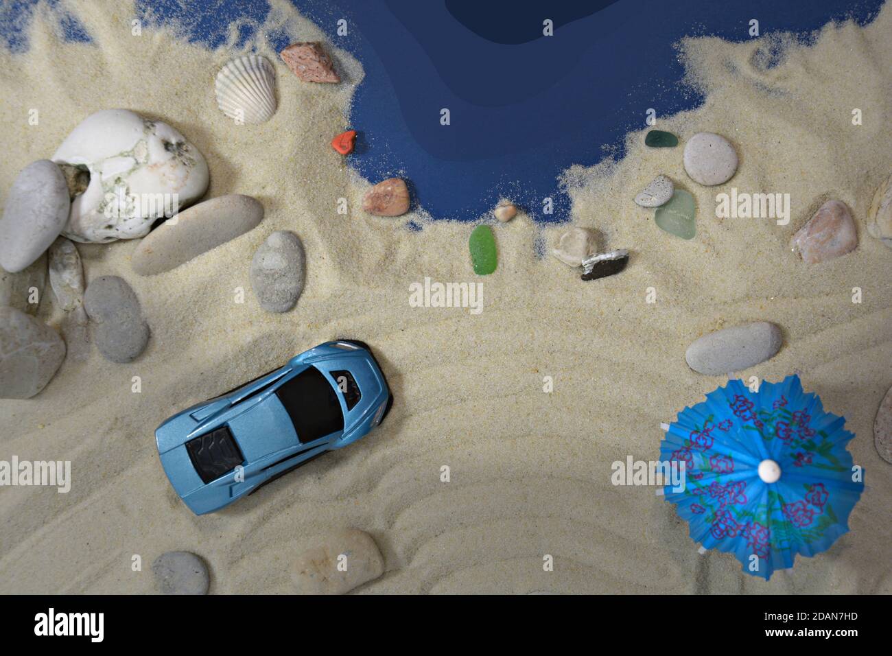 Blue car on a sandy beach near the sea Stock Photo - Alamy