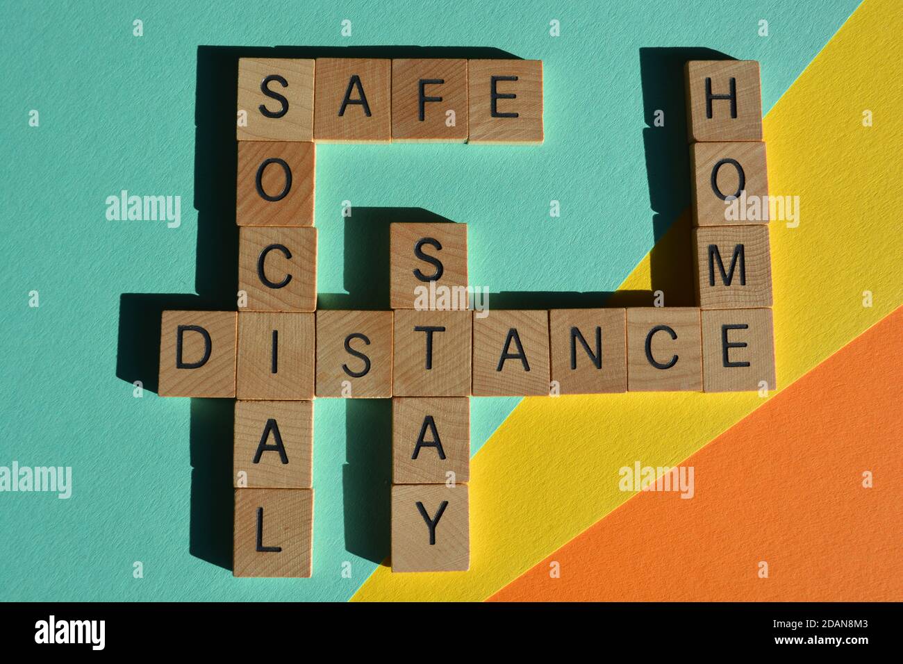 Social Distance Stay Safe Home words in crossword form in wooden