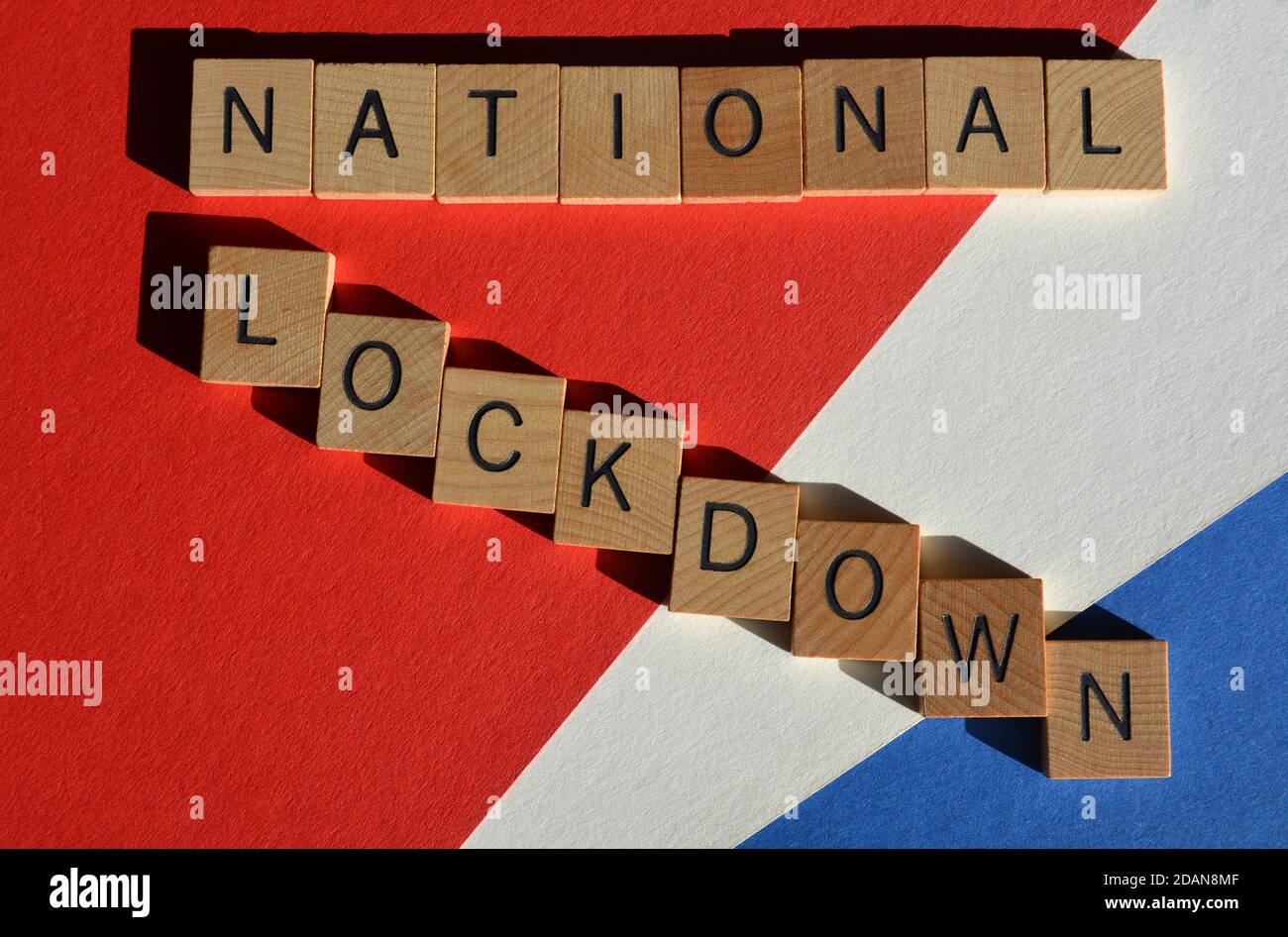 National :ockdown, words in wooden alphabet letters on red, white and blue background Stock Photo