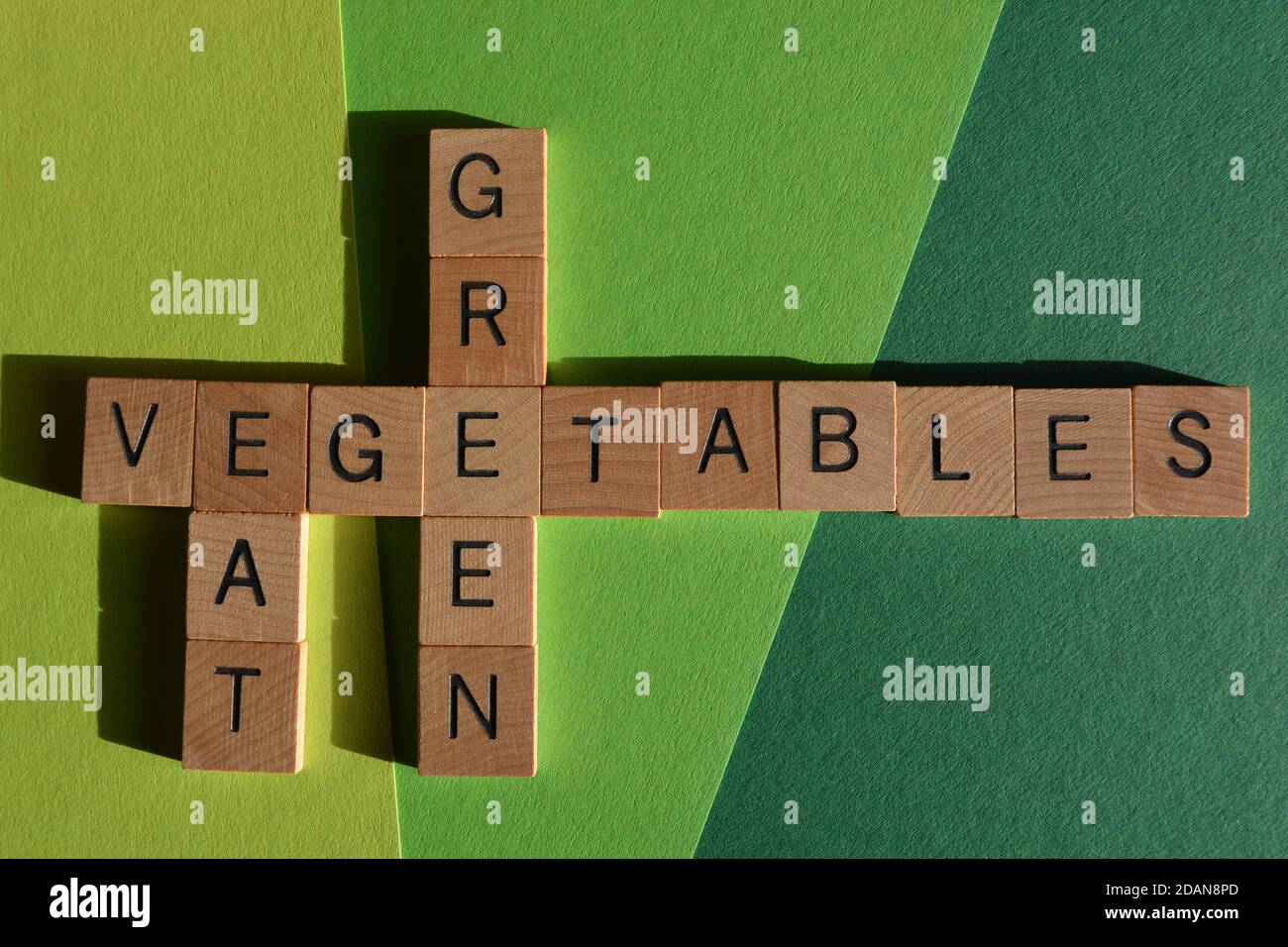 Eat, Green, Vegetables, words in wooden alphabet letters in crossword form isolated on green Eat, Green, Vegetables, words in wooden alphabet letters in crossword form isolated on green