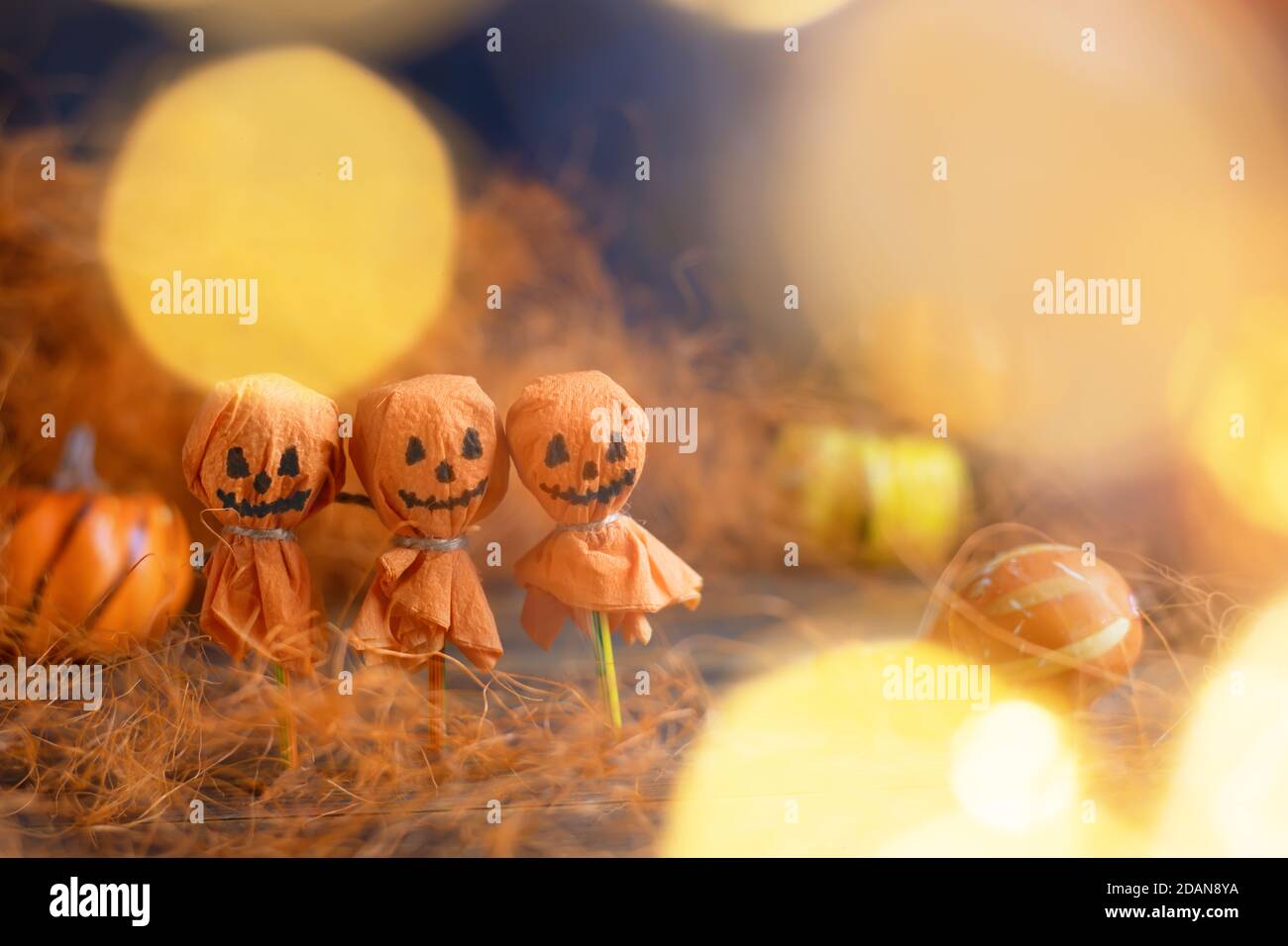 Three cheerful round lollipops converted into a pumpkin Stock Photo