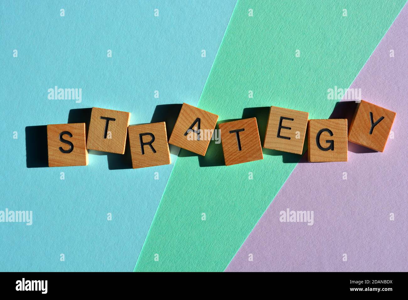 Strategy, word in wooden alphabet letters isolated on a pastel colored background Stock Photo