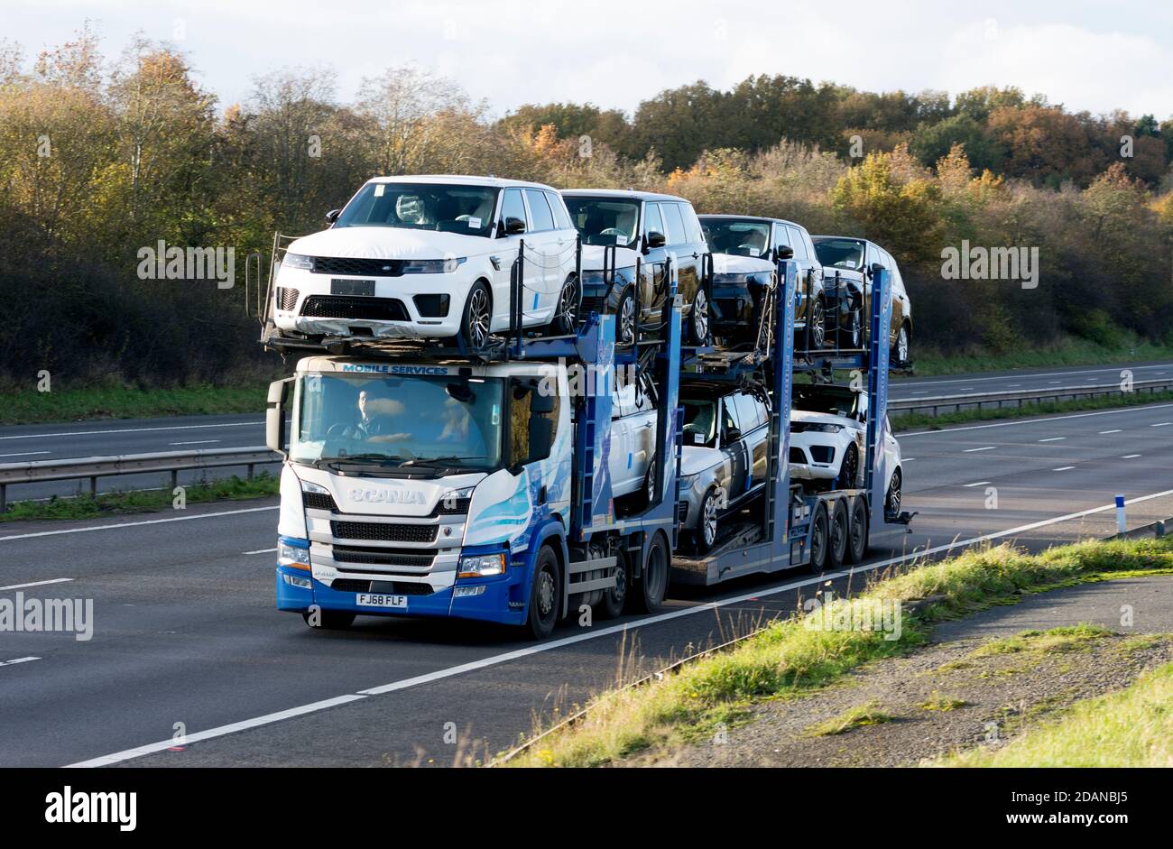 A Mobile Services transporter lorry carrying new Land Rover cars on the M40 motorway, Warwickshire, UK Stock Photo