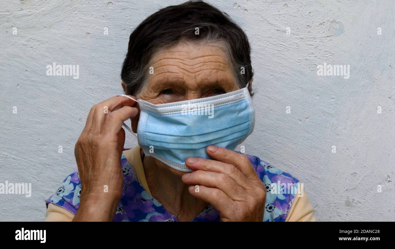Old lady shows wear mask hi-res stock photography and images - Alamy