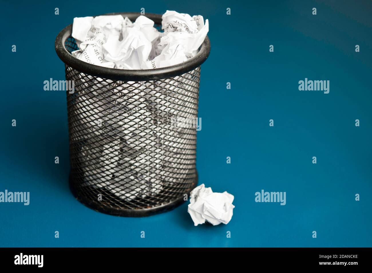 office bin filled with crumpled paper Stock Photo