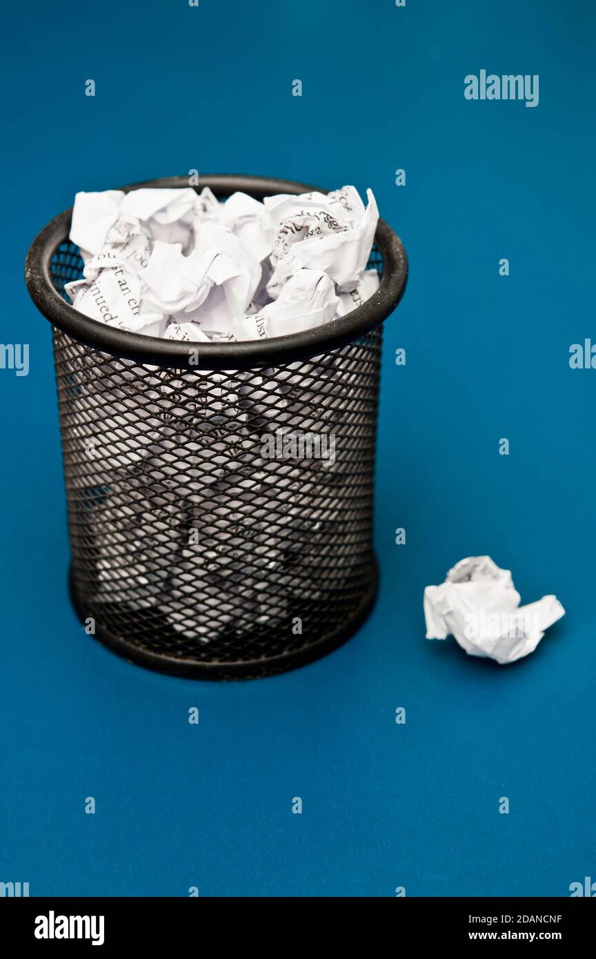 office bin filled with crumpled paper Stock Photo