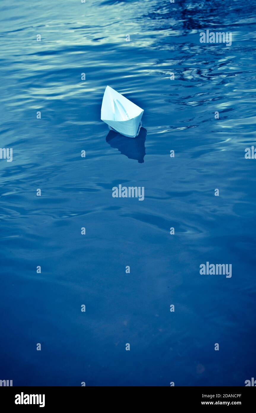paper boat floating in water Stock Photo Alamy