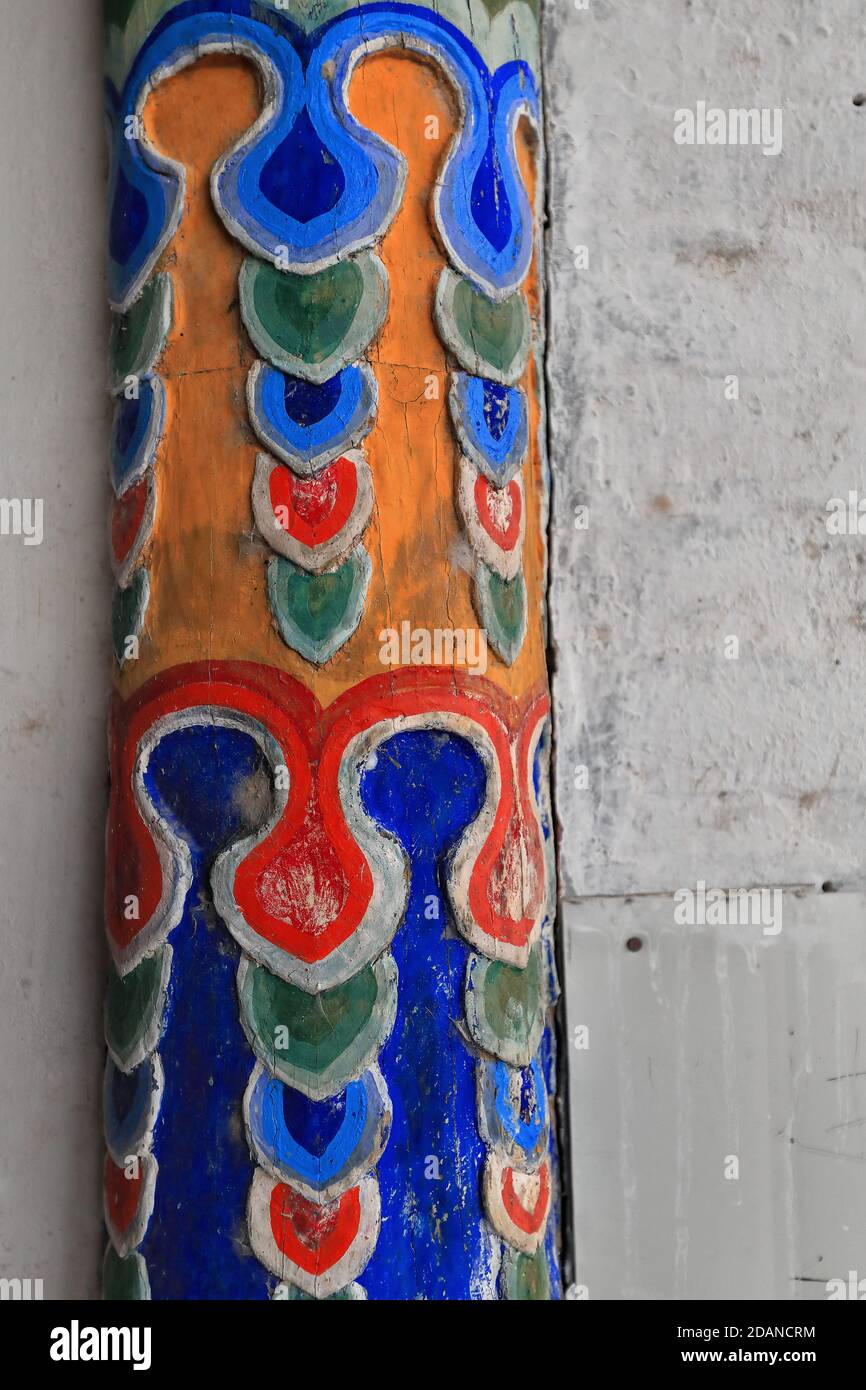 Detail-polychrome decoration-fine woodcarving-roof holding column. Entrance hall-Badain Jaran Temple-Inner Mongolia-China-1117 Stock Photo