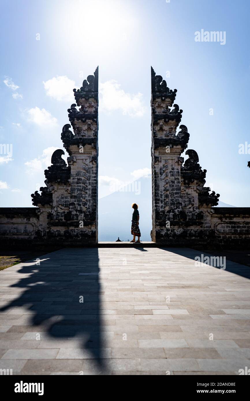 silhouette of a man standing on a stone wall Stock Photo