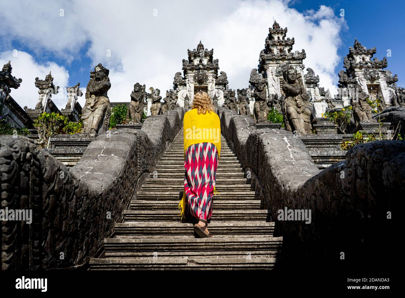 young woman standing on the stairs to temple Stock Photo