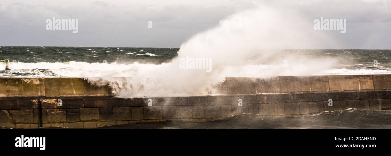 flooding over the Harbour wall crashing beyond the wall  Ray Boswell Stock Photo