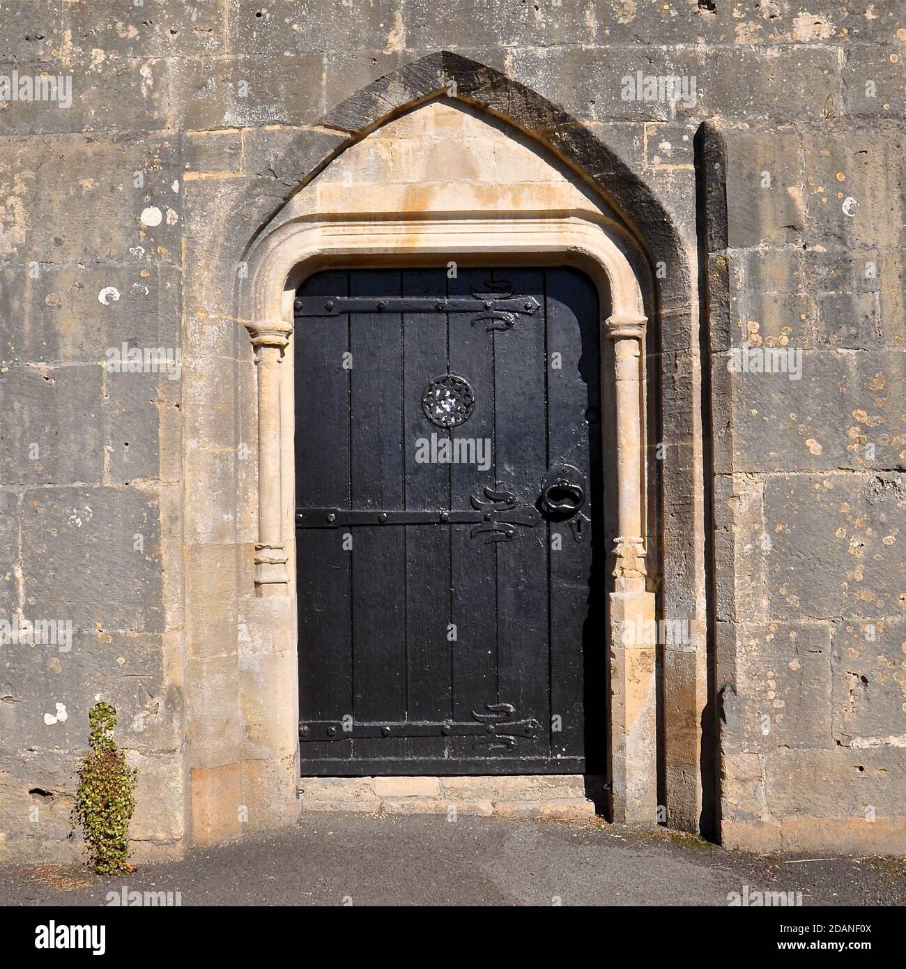 Black wooden Gothic style arched doorway in an old English church. Stock Photo