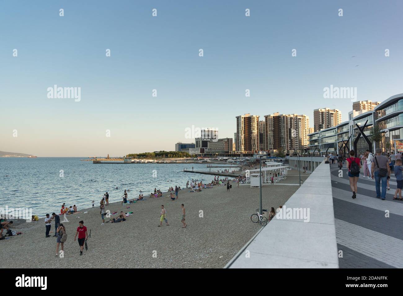 Russia, Novorossiysk, July 11, 2020: Evening embankment of Admiral Serebryakov and the Central beach of the black sea city. Citizens and guests relax Stock Photo
