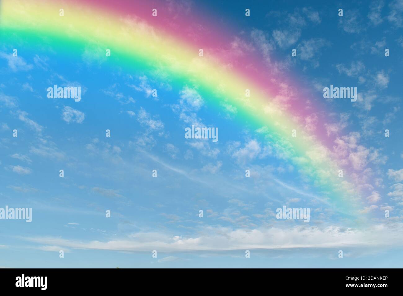 Rainbow on blue sky with white cloud background Stock Photo - Alamy