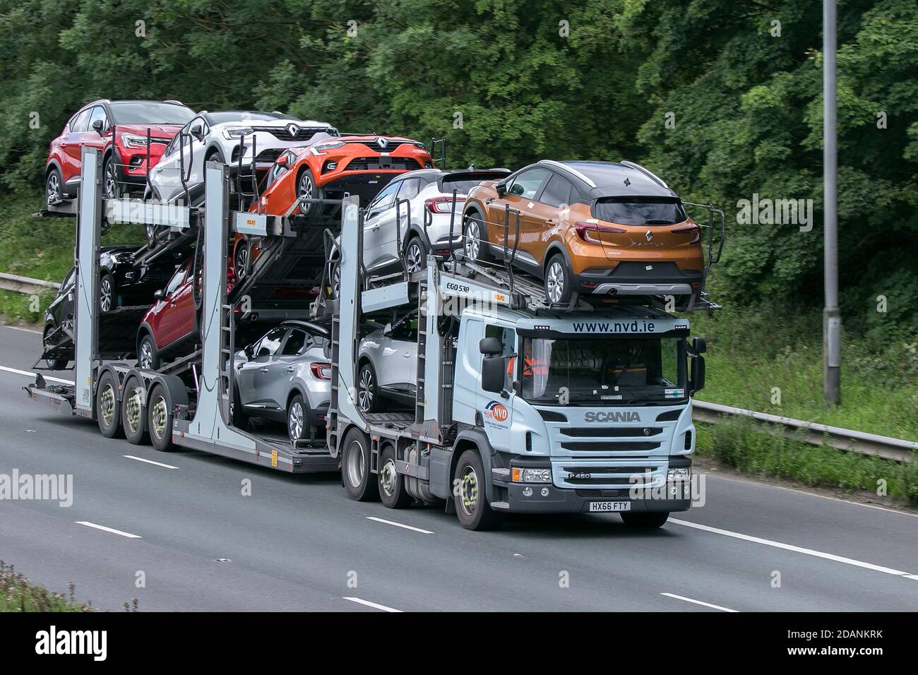 Scania P450 ,  NVD (National Vehicle Distribution) car transporter driving on the M6 motorway near Preston in Lancashire, UK. Stock Photo