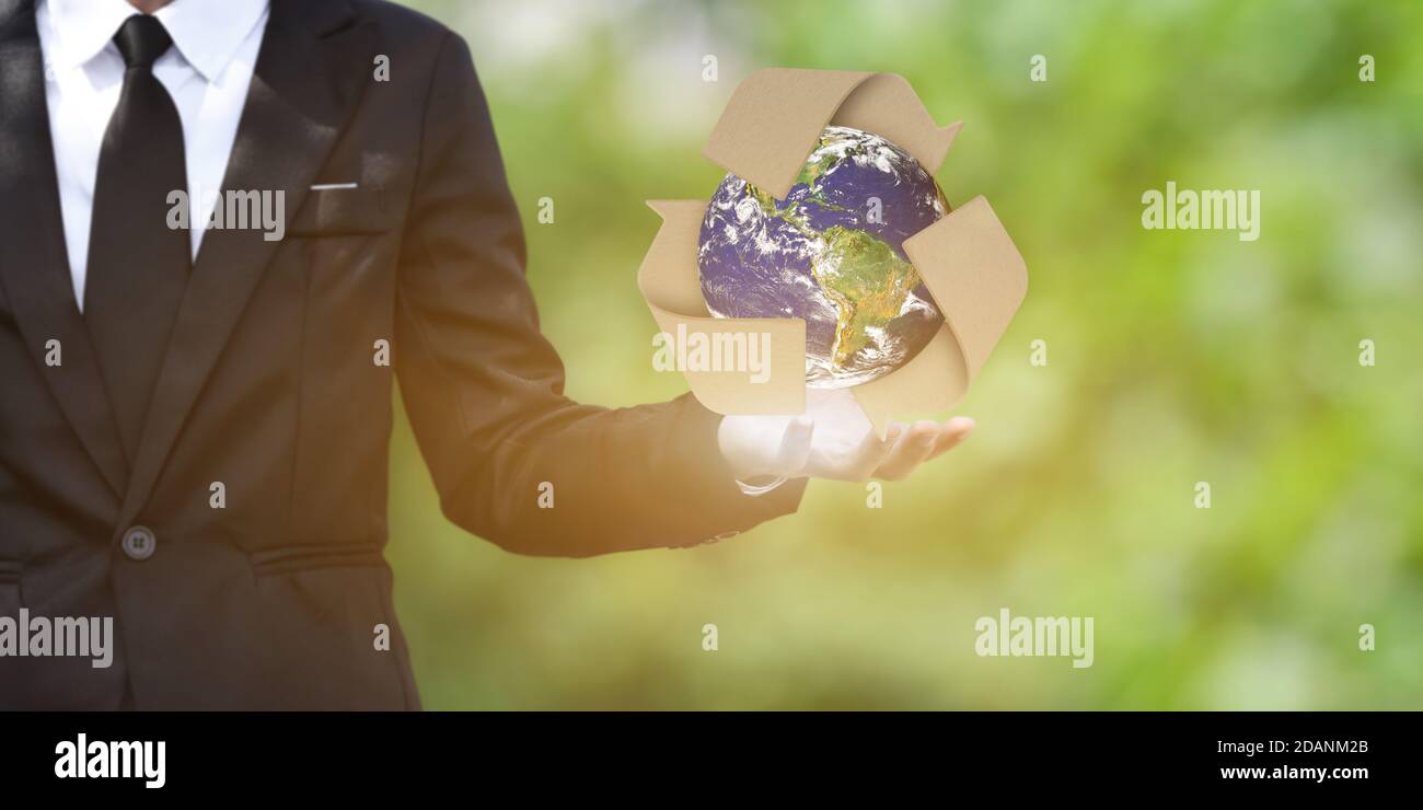 World earth day concept. Businessman show outstretched hand with Earth and recycling symbol on green bokeh background. Elements of this image furnishe Stock Photo