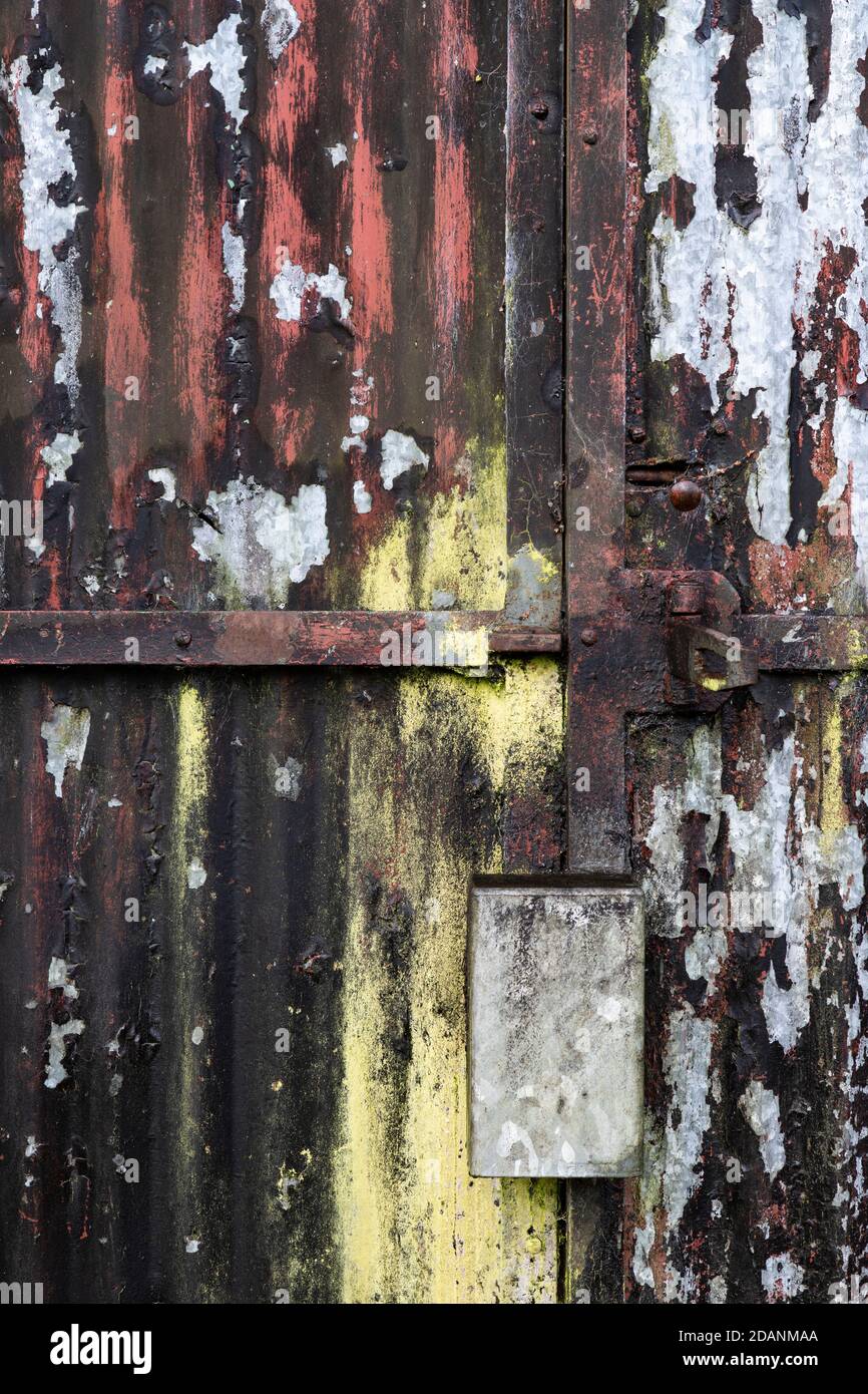 Old corrogated iron door with peeling paint Stock Photo