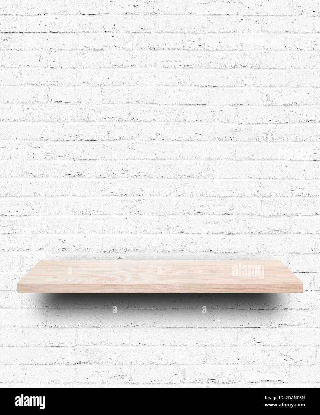 Empty wooden shelf on white brick wall background. Stock Photo