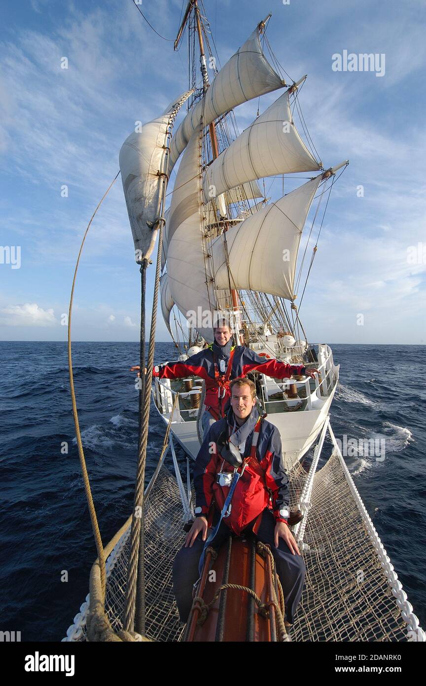 Titanic Pose on The Prince William, a square-rigged brig, and used as a training shipsailing across the Atlantic from the Azores to Dingle in Ireland Stock Photo