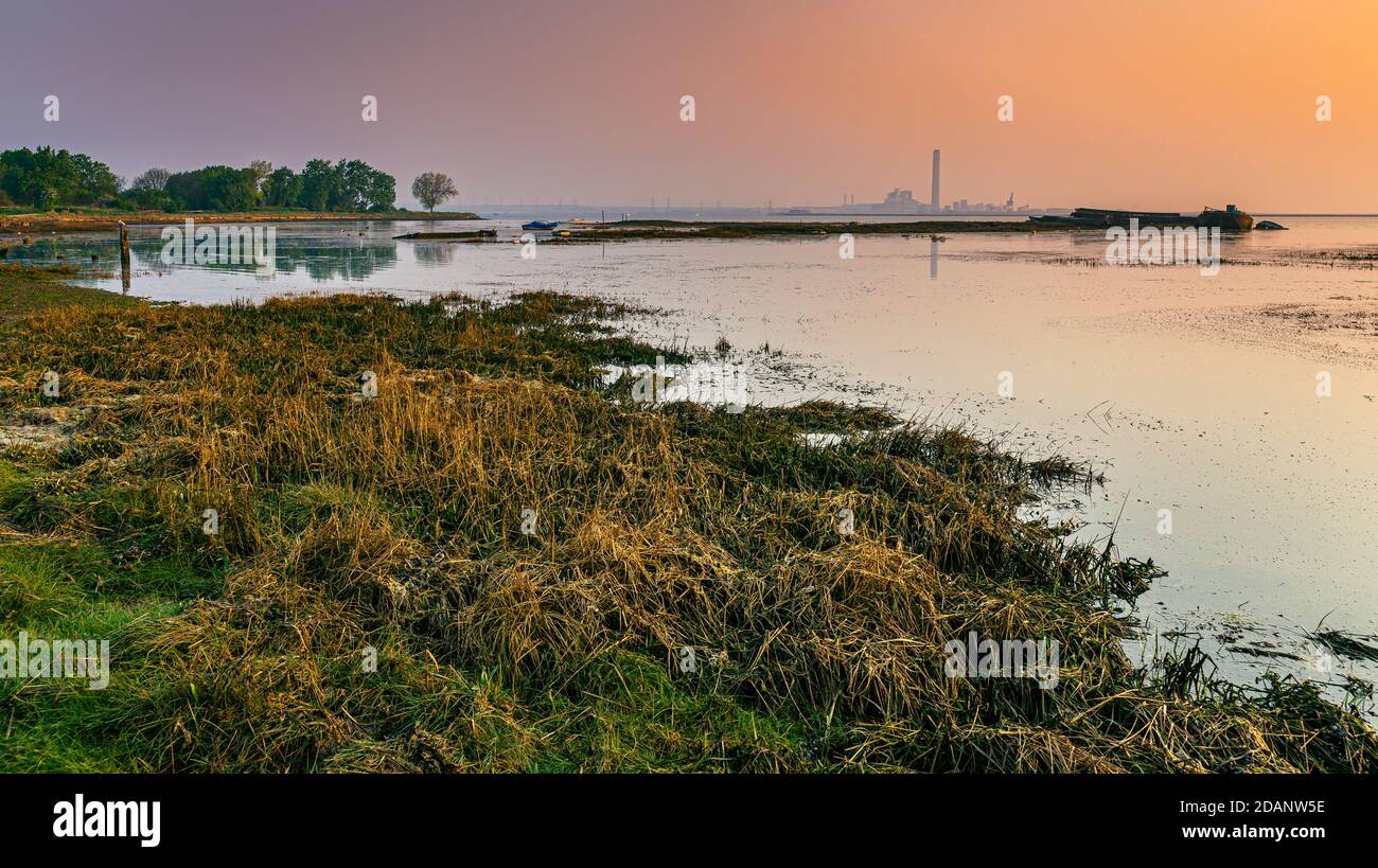 Kingsnorth Power Station At Sunrise On The Isle Of Grain Looking From The Riverside Country Park In Medway Kent Stock Photo