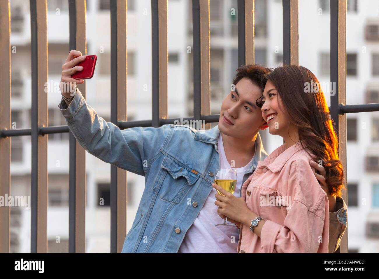 young happy couple lover and romantic at first date relationship. cute asian boyfriend using smartphone to selfie with her girlfriend at sweet dinner Stock Photo