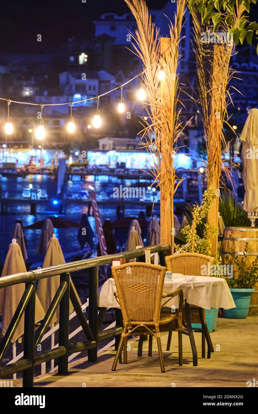 Restaurant table near the Aegean sea at night, Turunc, Turkey Stock Photo
