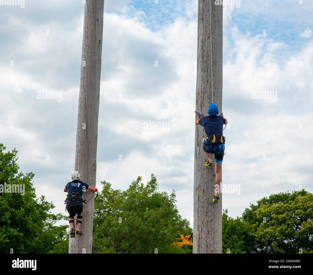 Kent County Show , UK - JULY 07 2017 :Competitors climb a 25m tall pole to see who is the fastest in a pole climbing competition Stock Photo