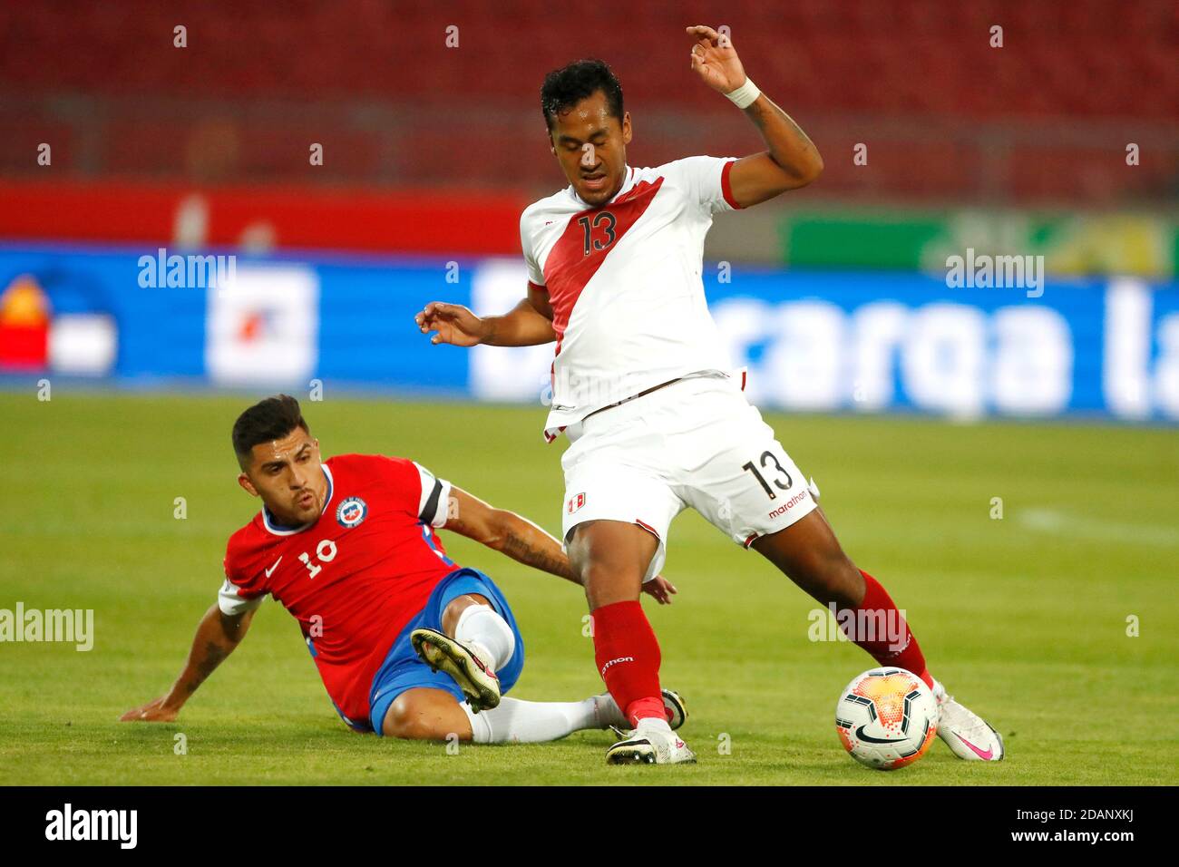 13th November 2020; National Stadium of Santiago, Santiago, Chile; World Cup 2020 Football qualification, Chile versus Peru;  Cesar Pinares of Chile slides in on Renato Tapia of Peru Stock Photo