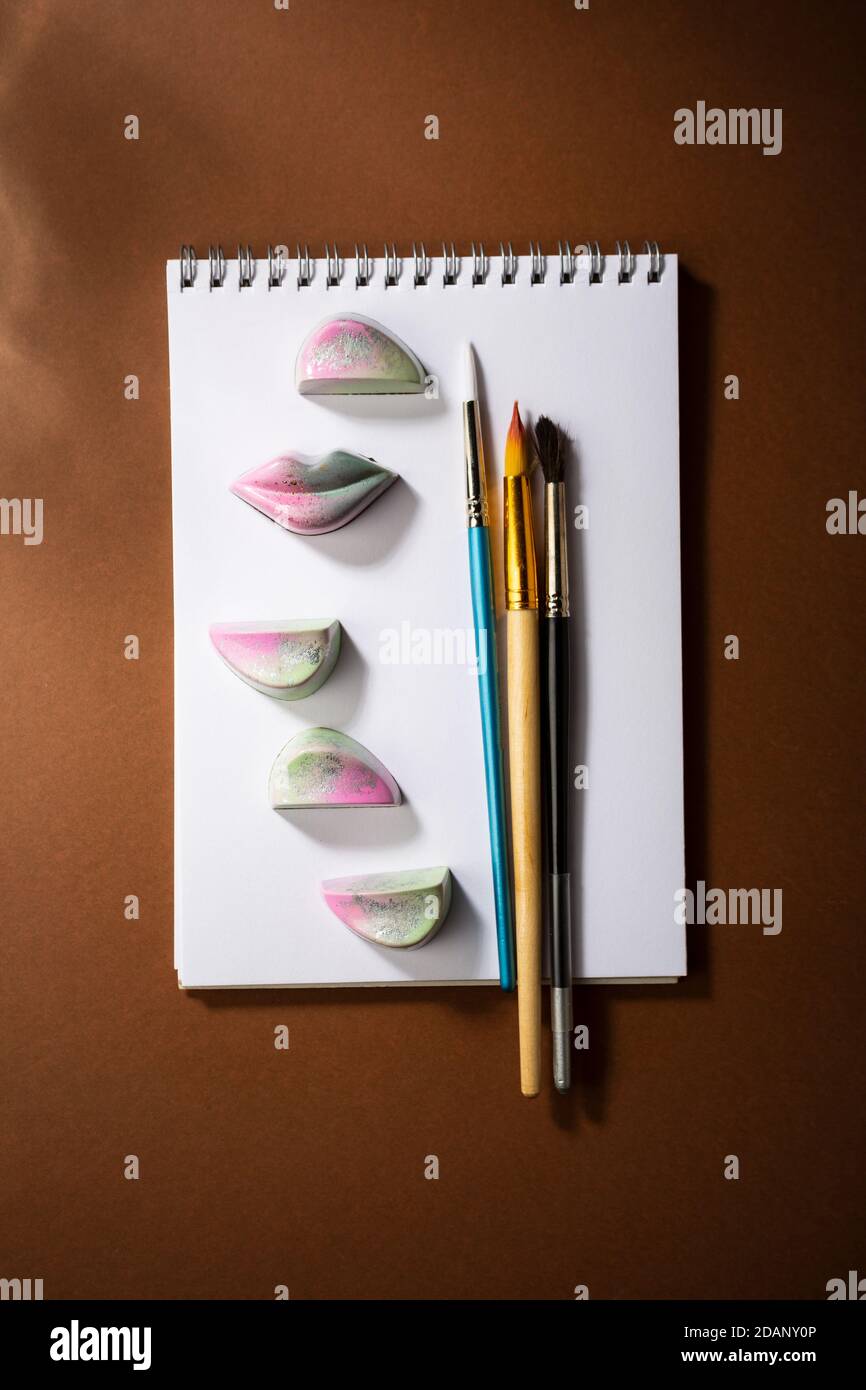 Chocolate candies and paint brushes Stock Photo Alamy