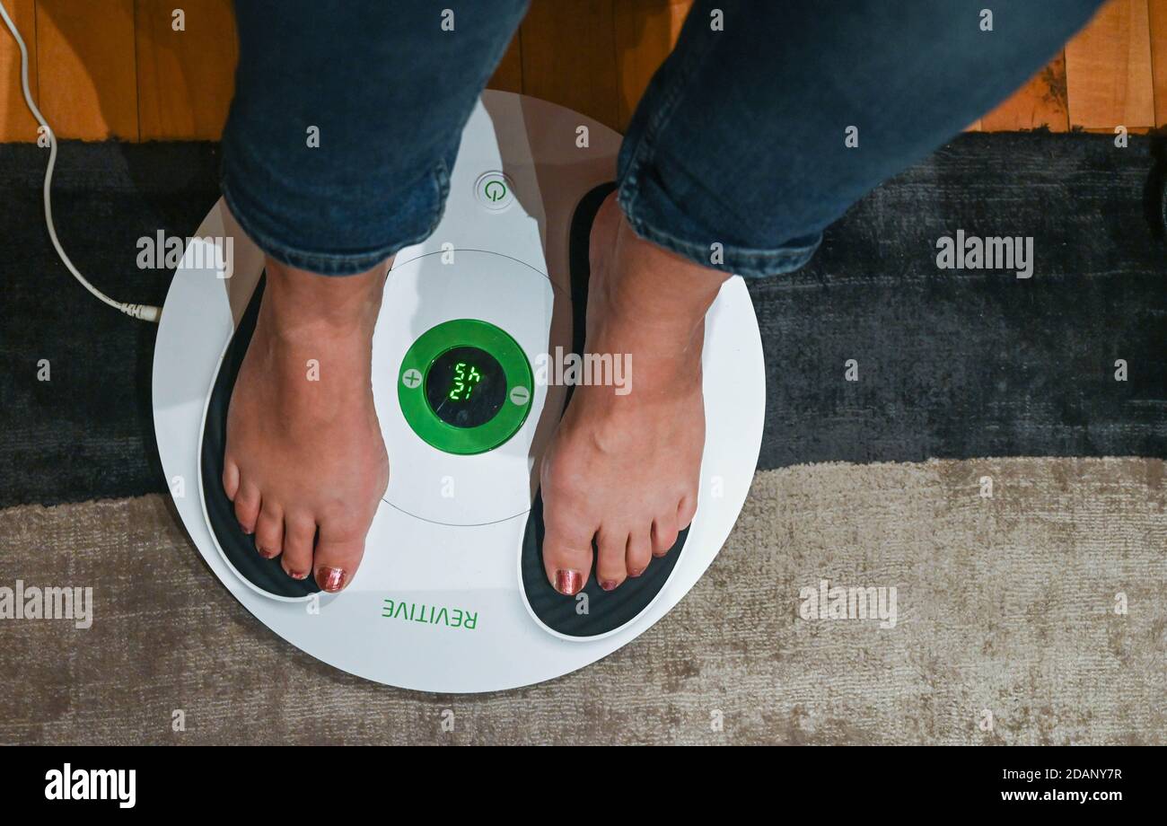 Revitive Medic Circulation Booster actively improves the circulation by  stimulating the muscles in legs and feet using Electrical Muscle  Stimulation Stock Photo - Alamy