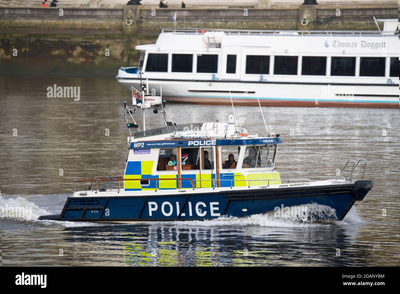Views over the Thames from the Victoria Tower Gardens London  Metropolitan river police launch Stock Photo