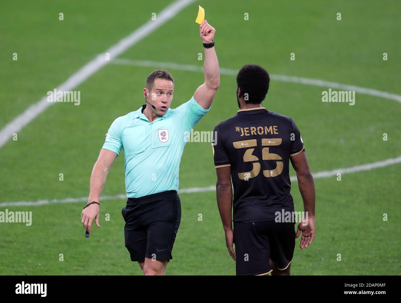 Referee John Brooks (left) shows a yellow card to Milton Keynes Dons' Cameron Jerome for unsporting behaviour during the Sky Bet League One match at the Stadium of Light, Sunderland. Stock Photo