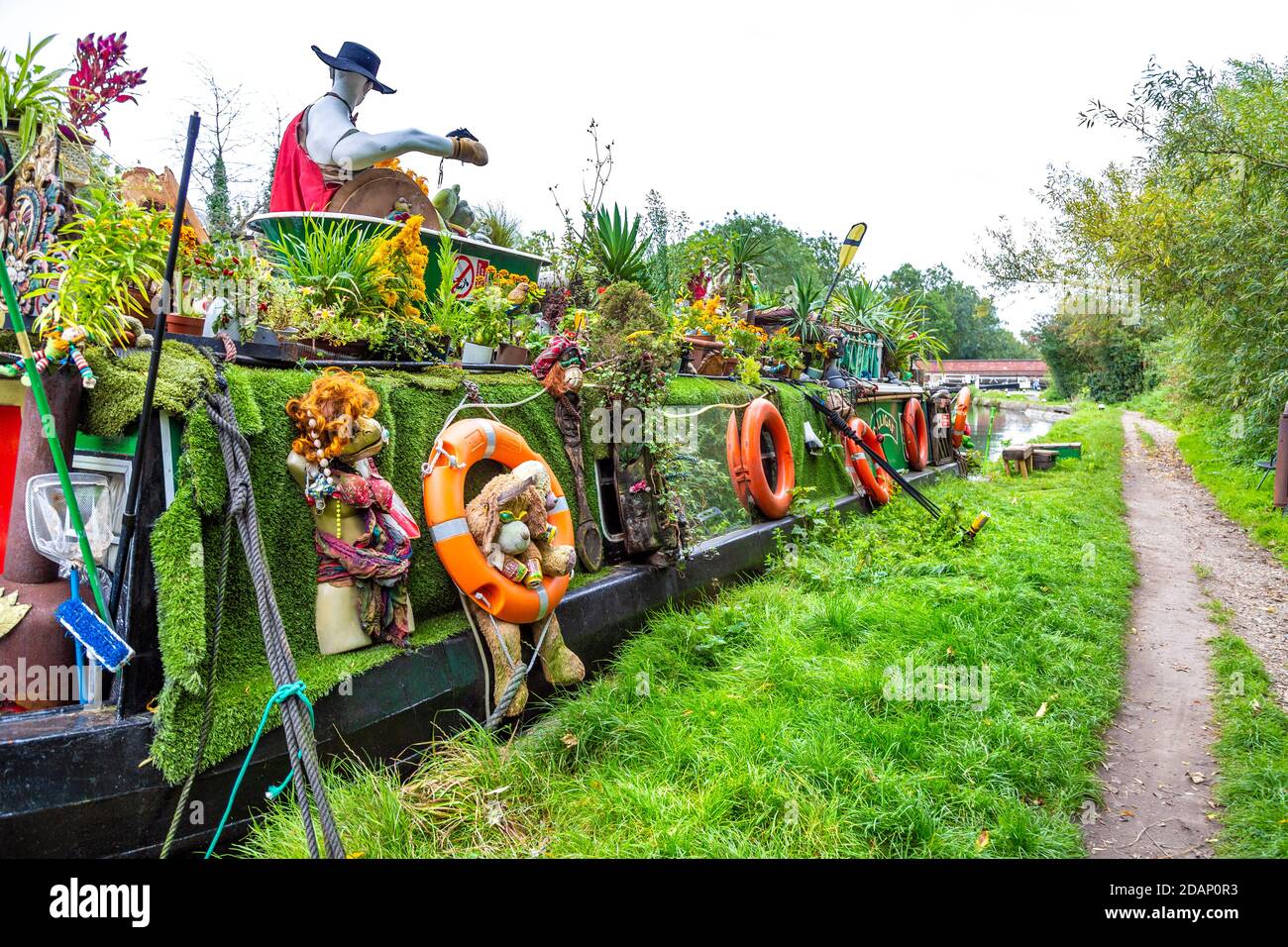 An unusual, decorated barge houseboat along the Grand Union Canal in Colne Valley, Uxbridge, UK Stock Photo