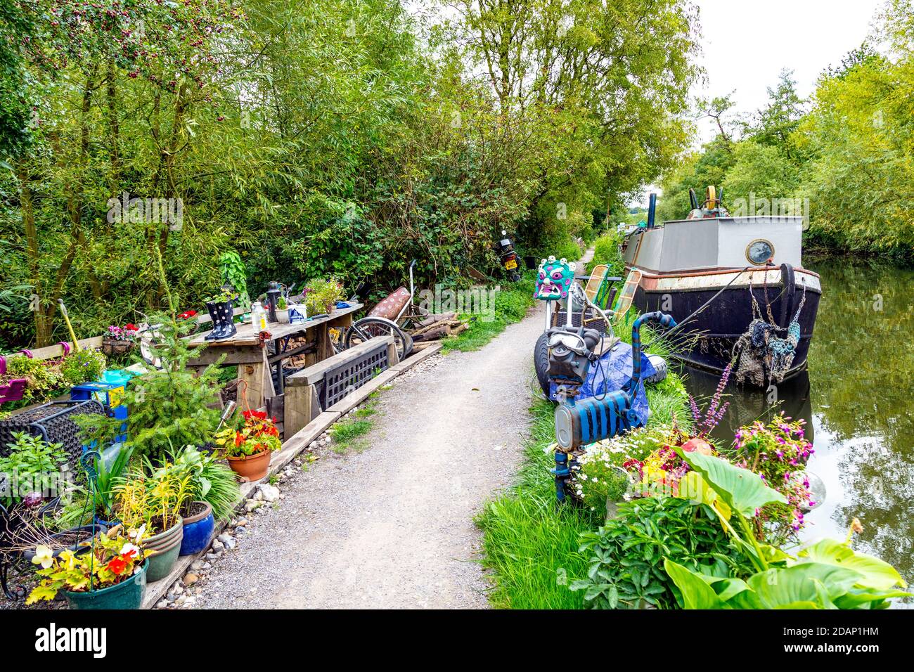 A richly decorated, unusual garden of a houseboat owner along the Grand Union Canal, Colne Valley, UK Stock Photo
