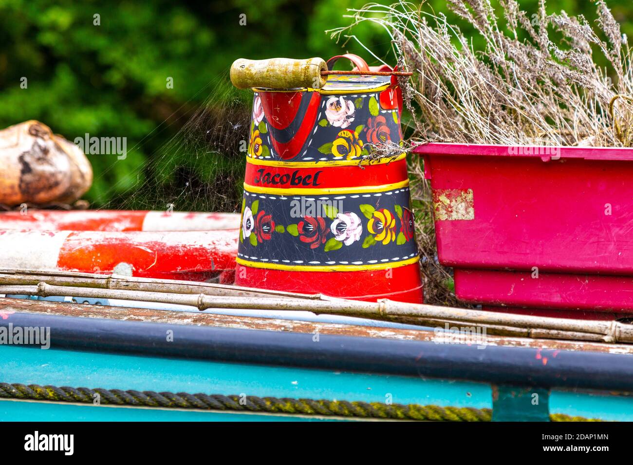 Bucket on top of a naoorboat painted in the folk roses & castles style, Grand Union Canal, Colne Valley, UK Stock Photo