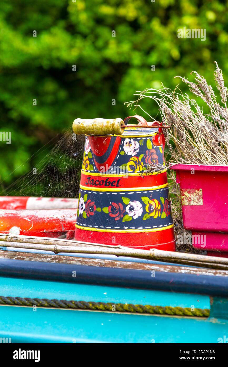 Bucket on top of a naoorboat painted in the folk roses & castles style, Grand Union Canal, Colne Valley, UK Stock Photo