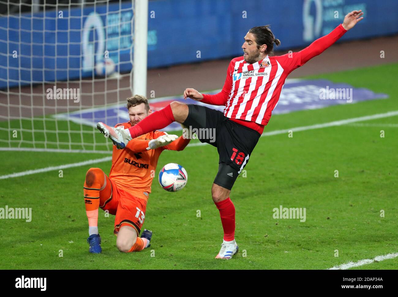 Milton Keynes Dons goalkeeper Andrew Fisher (left) and Sunderland's Danny Graham battle for the ball during the Sky Bet League One match at the Stadium of Light, Sunderland. Stock Photo