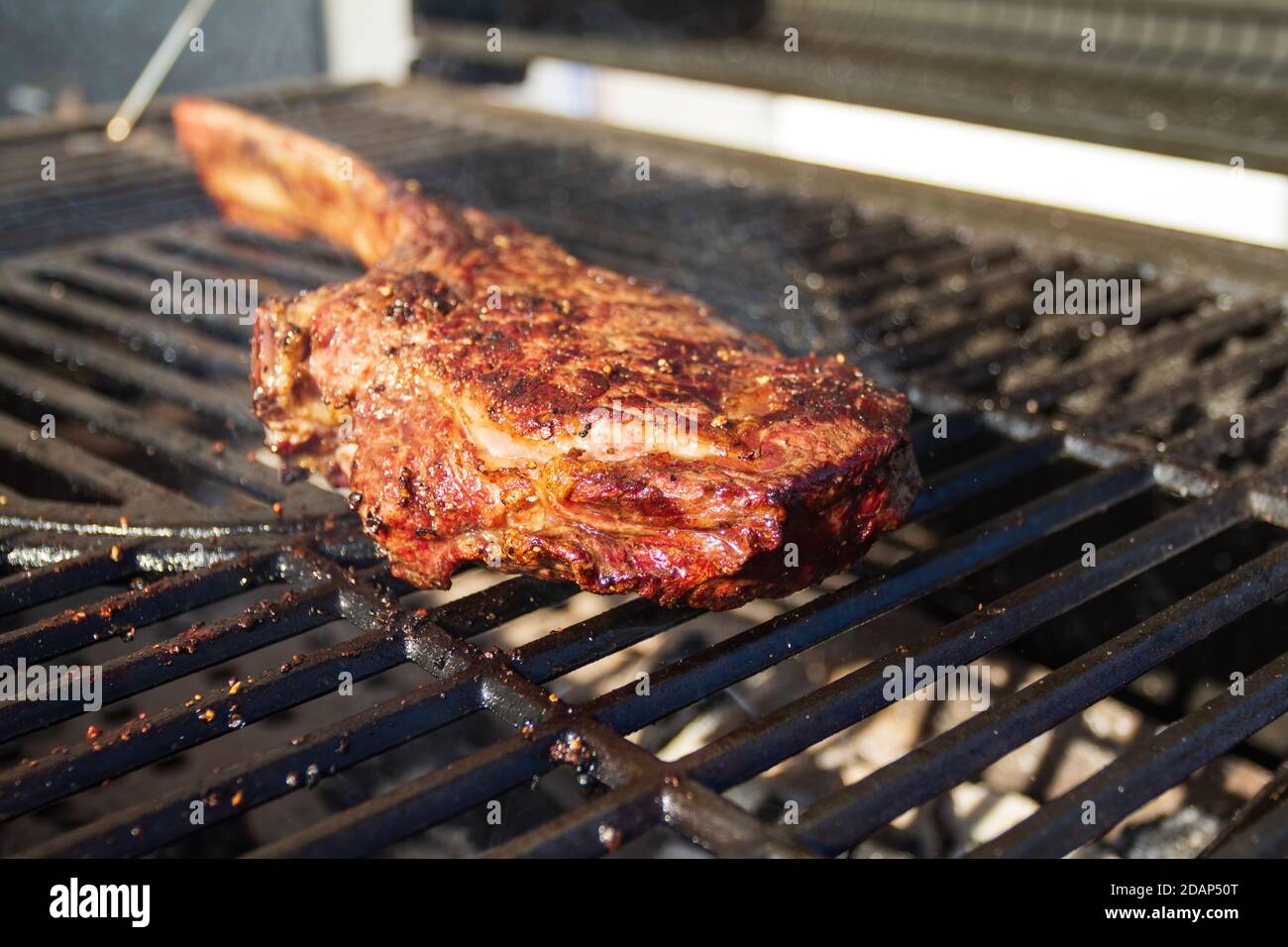 Dry Aged Barbecue Tomahawk Steak on grill Stock Photo