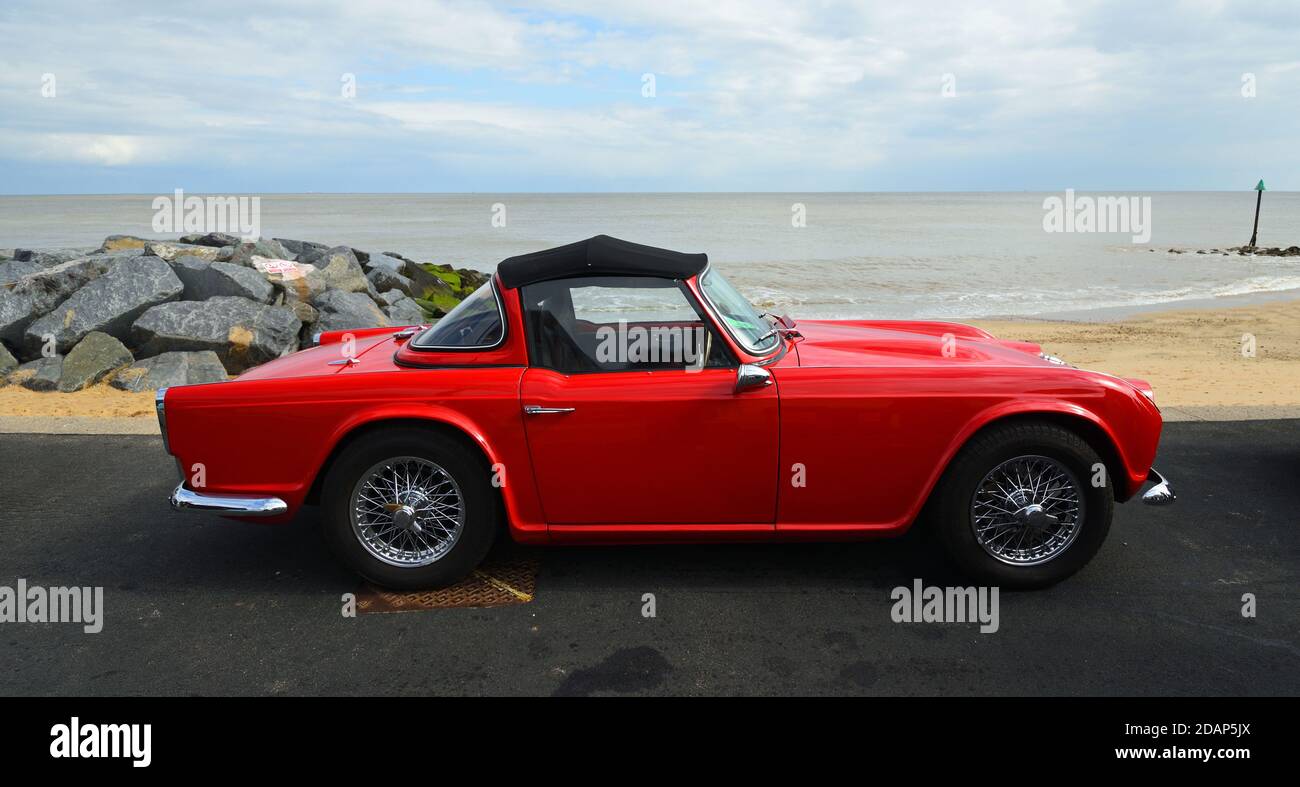 Classic red Triumph TR4  Convertible parked on seafront promenade. Stock Photo
