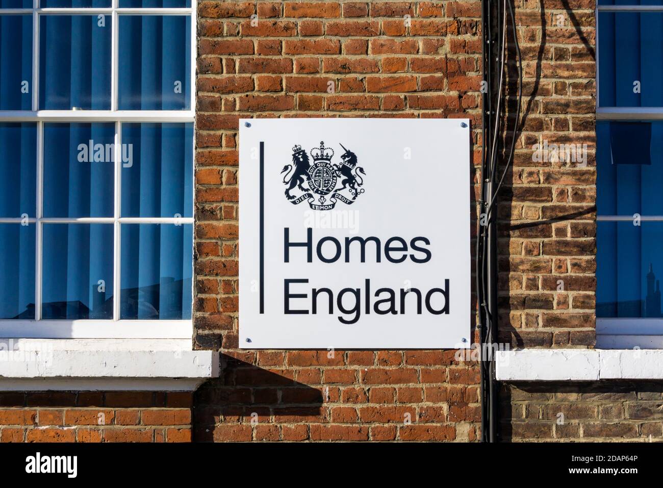 A sign for Homes England described on their website as 'the government’s housing accelerator'. It funds new affordable housing. Stock Photo