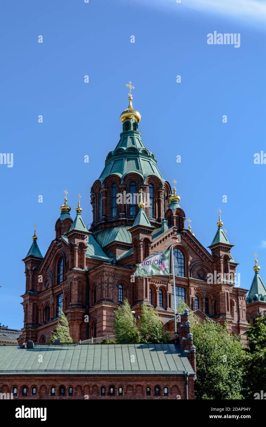 Red brick Uspenski Cathedral with green domes and golden crosses Stock Photo