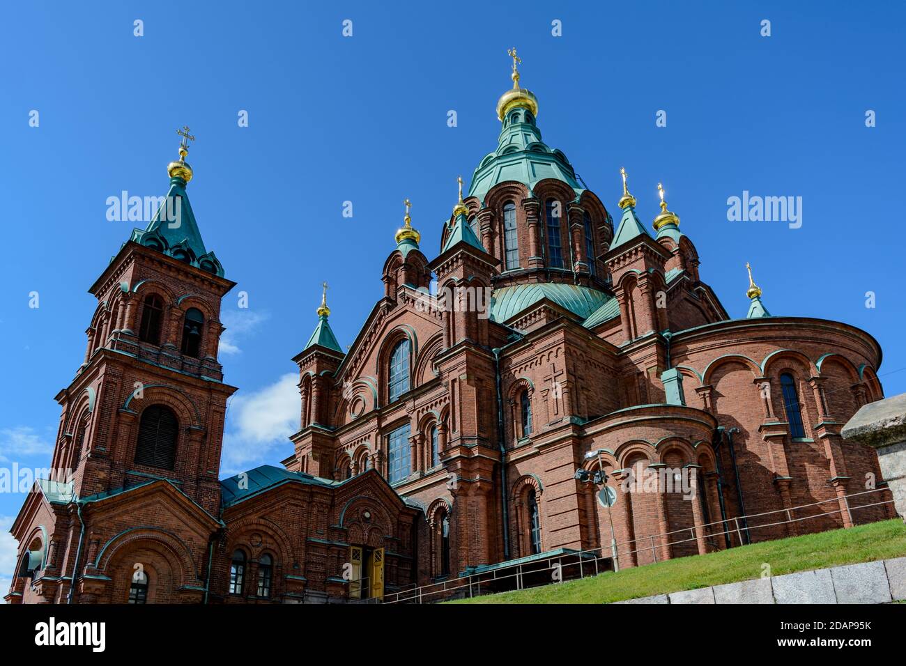 Red brick Uspenski Cathedral with green domes and golden crosses Stock Photo