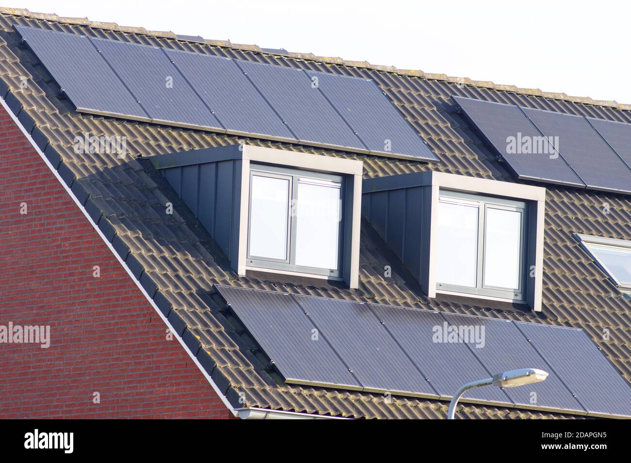 Solar panels on a brown roof with dormer for electric power generation Stock Photo Alamy