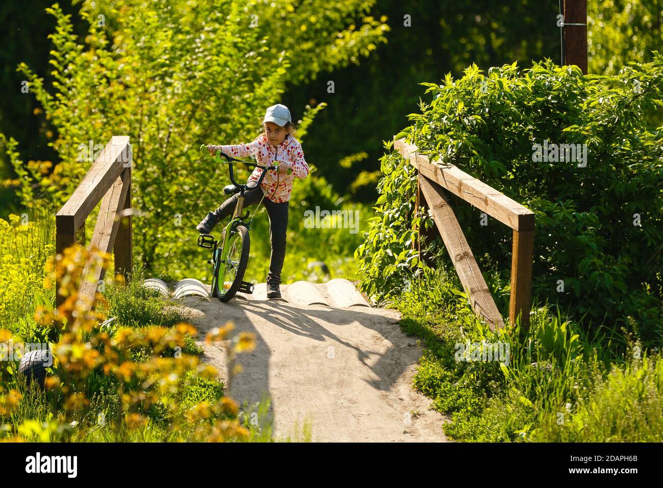 Portrait of a little girl on a bicycle in summer park outdoors Stock ...