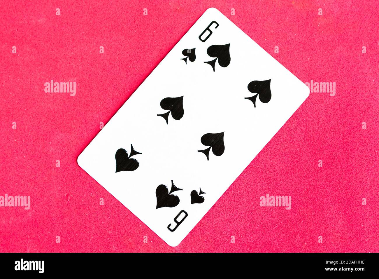 Six of Spades playing card, red background. Stock Photo
