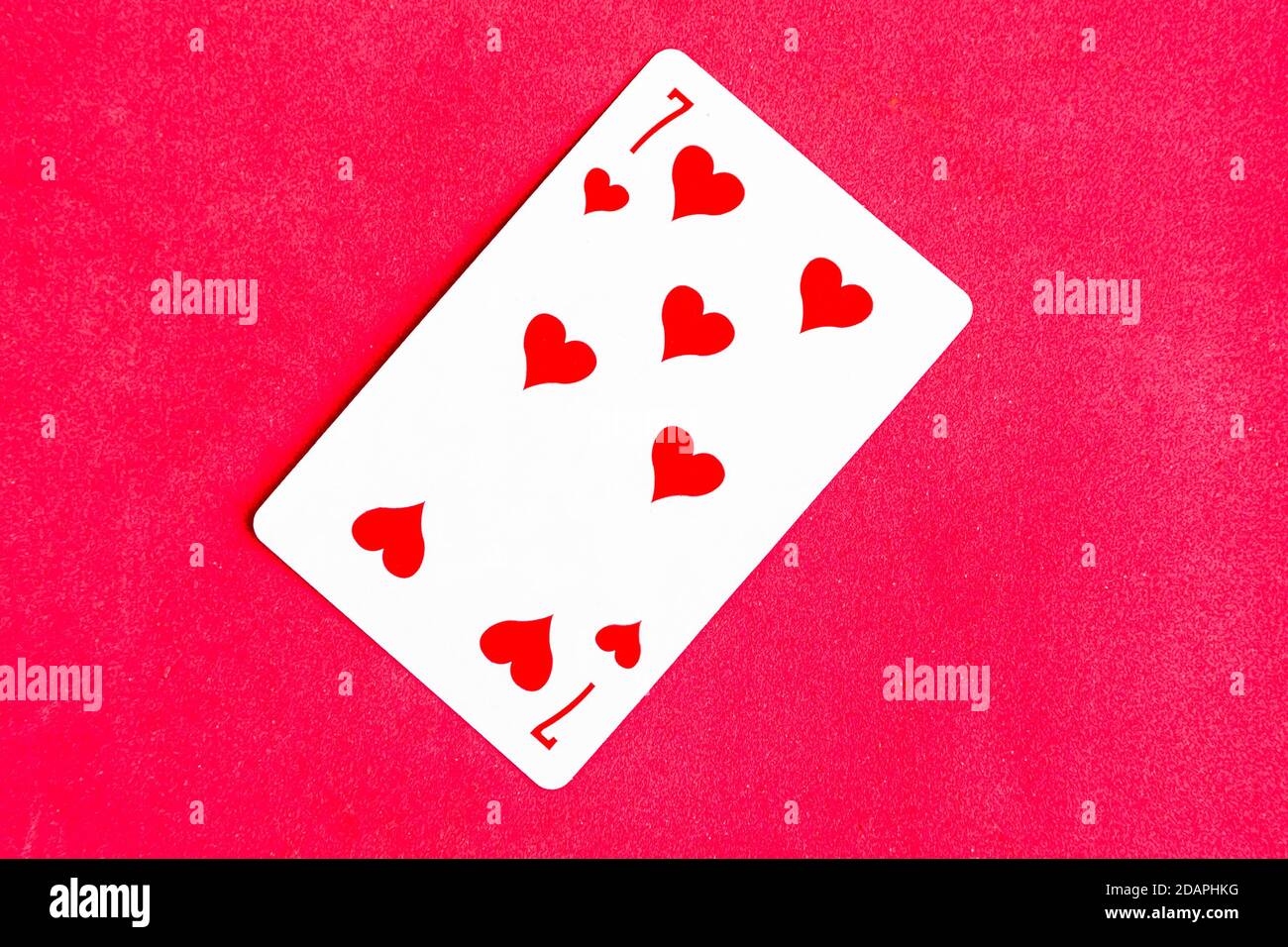 Seven of Hearts playing card, red background Stock Photo - Alamy