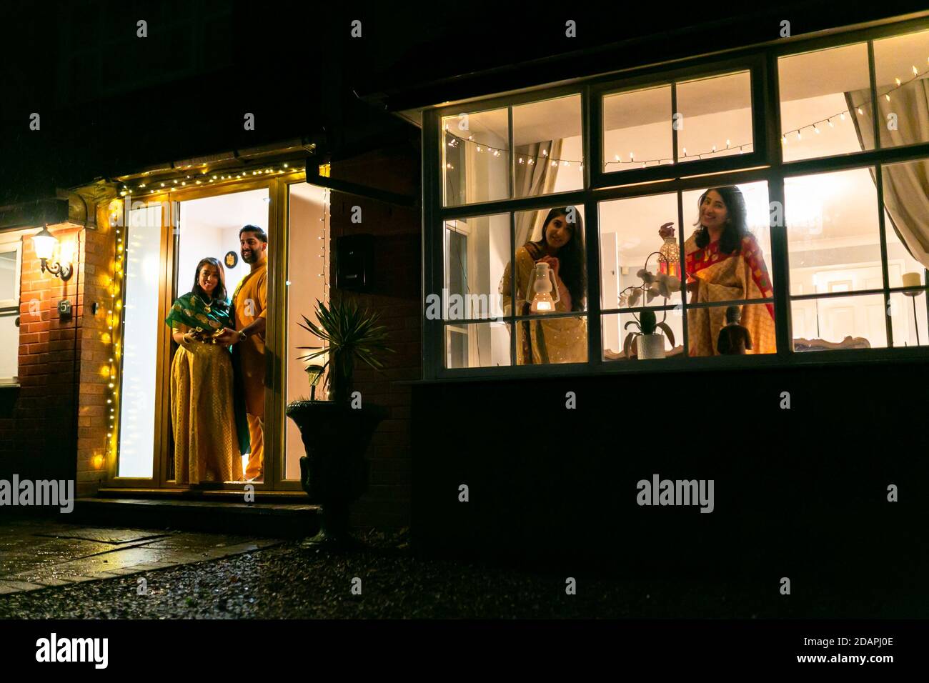 14th Nov, 2020. Nikil Kenth with his wife Sunie, and mother-in-law and sister Deepali and Surbhi, celebrate the last day of Diwali - or Festival of Light - at their home in Solihull, West Midlands, UK. Due to the current Covid lockdown conditions in England, the normally sociable and party atmosphere has been severely limited, and the UK's Hindu communities are forced to celebrate and pay their devotions at home with their family bubbles. Credit: Peter Lopeman/Alamy Live News Stock Photo