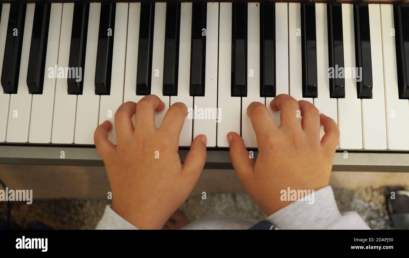Top view of child's hands playing piano Stock Photo - Alamy