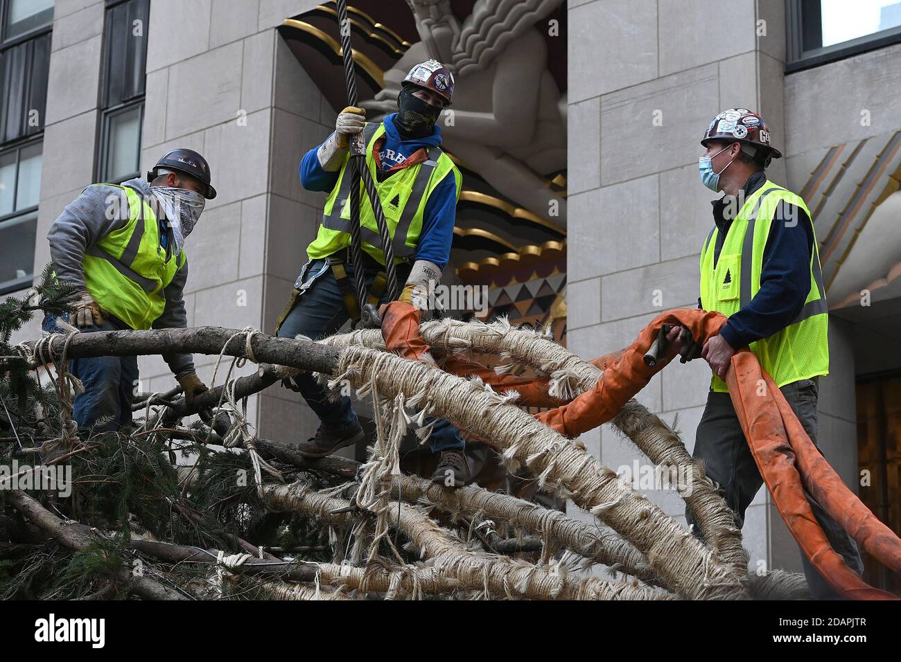 New York City, USA. 14th Nov, 2020. Riggers attache a crane cable to a ...