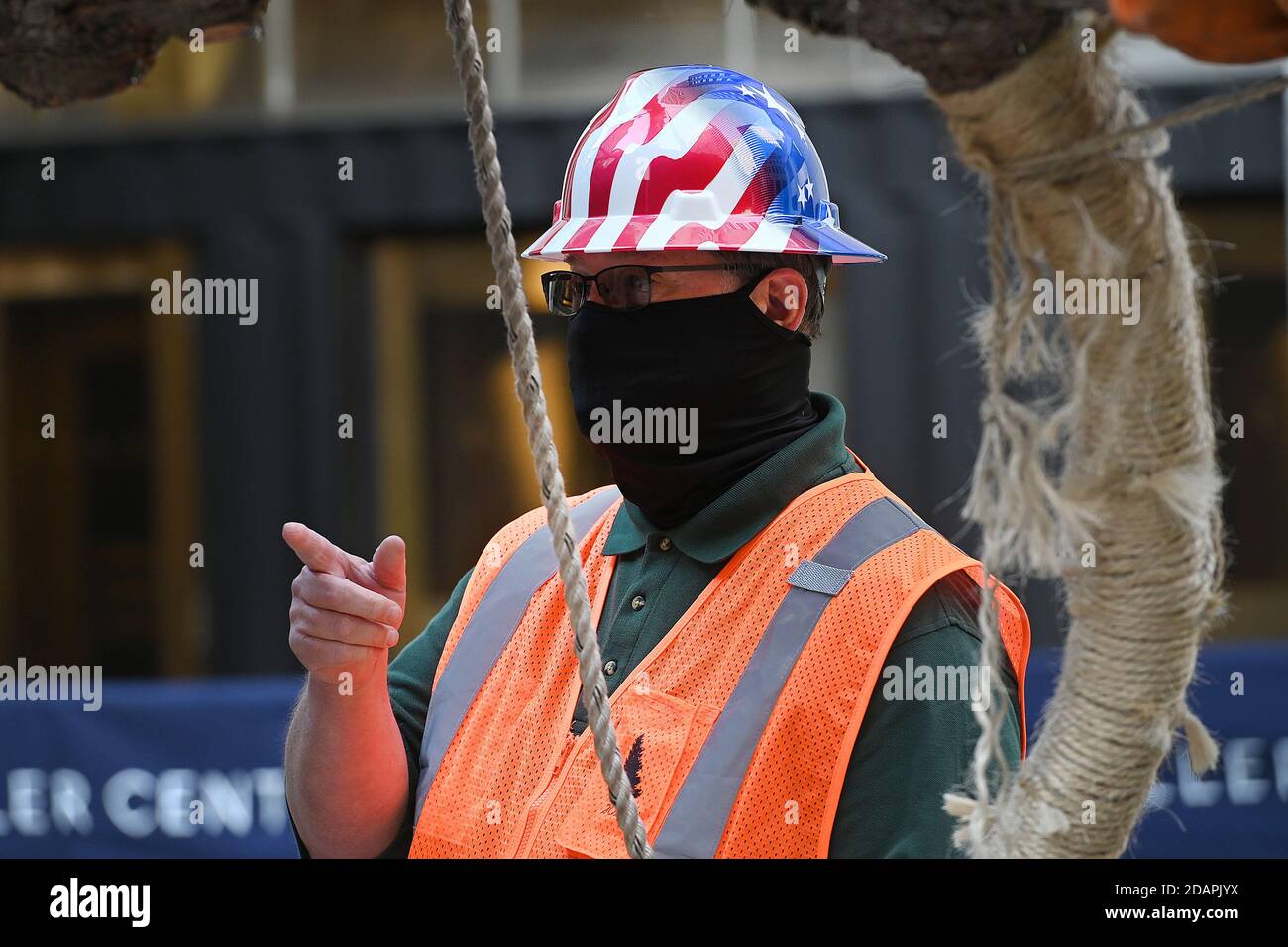 New York City, USA. 14th Nov, 2020. Erik Pauze, head garden at Rockefeller Center, leads riggers in the placement of cable as they prepare to place the 2020 Rockefeller Center Christmas tree onto its platform at Rockefeller Center in New York, NY, November 14, 2020. The 75-foot tall tree is a Norway Spruce that was acquired in Oneonta, N.Y. (Anthony Behar/Sipa USA) Credit: Sipa USA/Alamy Live News Stock Photo